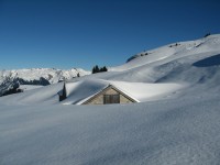 Vorbei an der tief verschneiten Alpe Sasberg.
